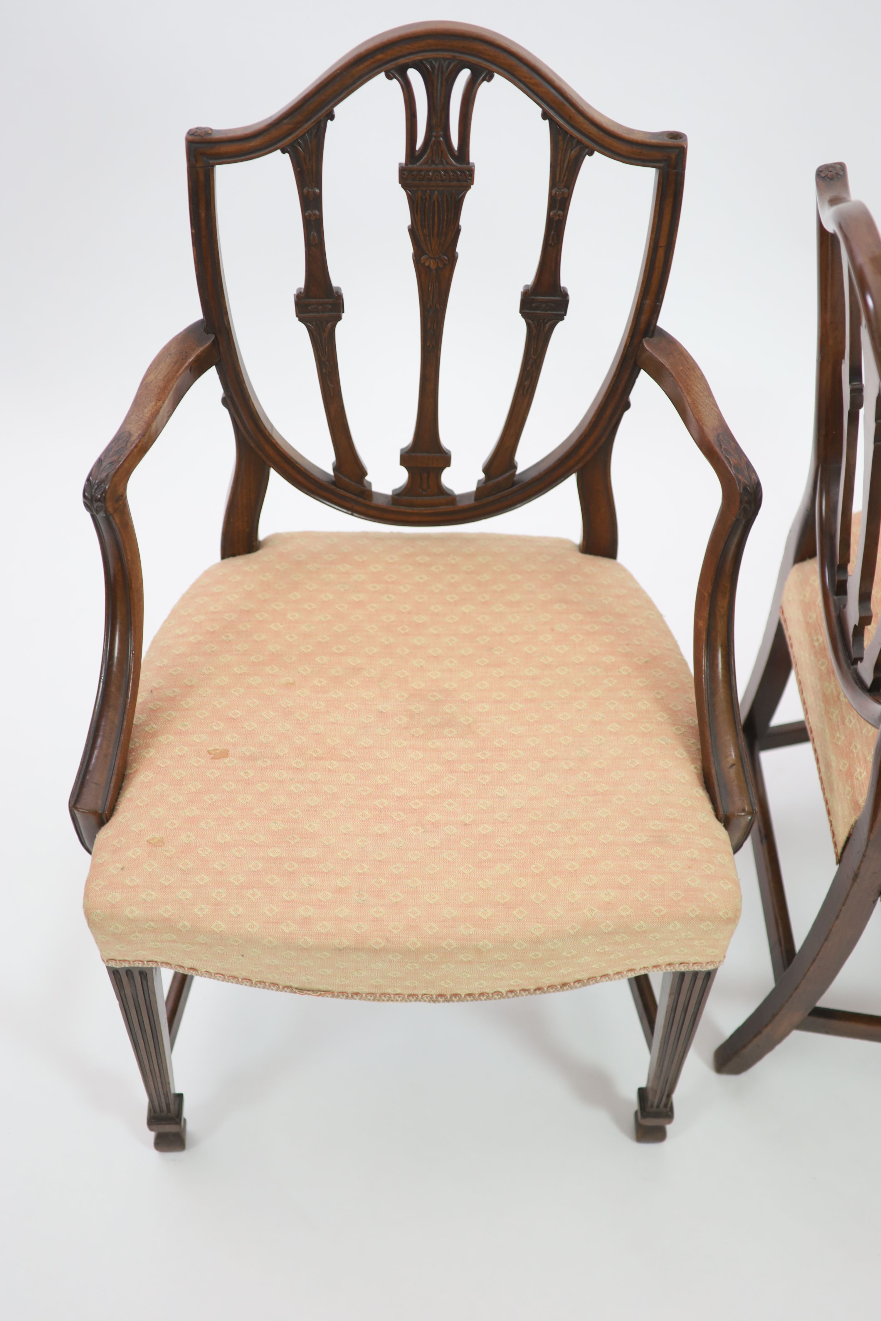 A pair of George III Hepplewhite style mahogany shield back elbow chairs, W.62cm H.97cm